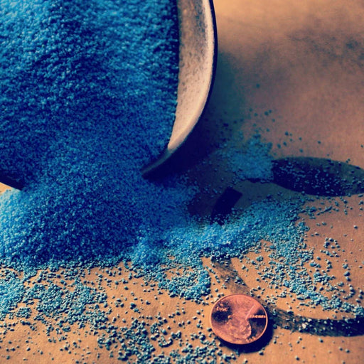 Close-up of blue copper sulfate crystals showcasing 99% pure copper sulfate pentahydrate for agricultural and pond management uses